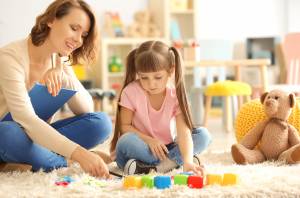 Teacher and children playing